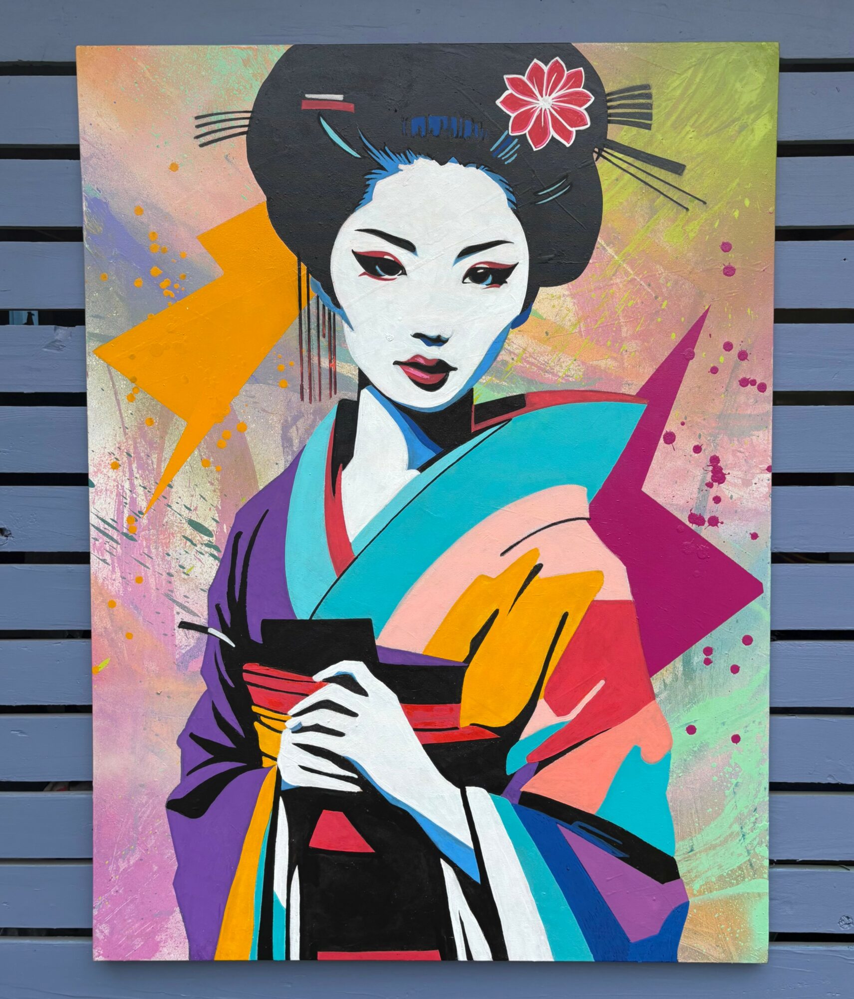 Colorful painting of a geisha with traditional attire and hairstyle, holding a fan, against a vibrant abstract background.