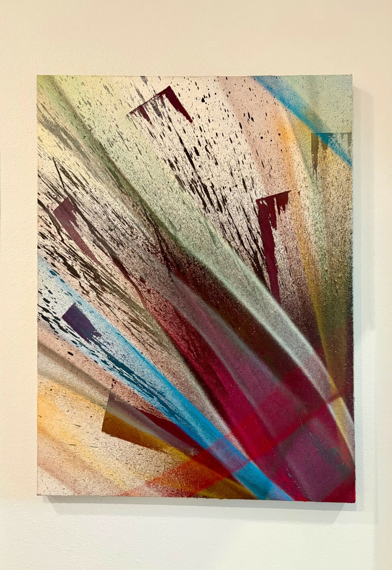 Abstract artwork with colorful streaks and geometric shapes on a white background.
