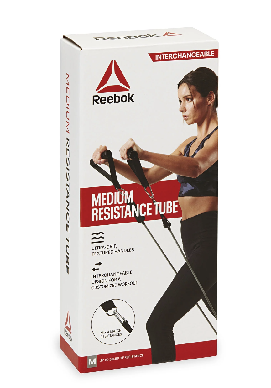 Reebok resistance tube with a woman exercising, labeled medium resistance, textured handles, and interchangeable design, in red and white packaging.