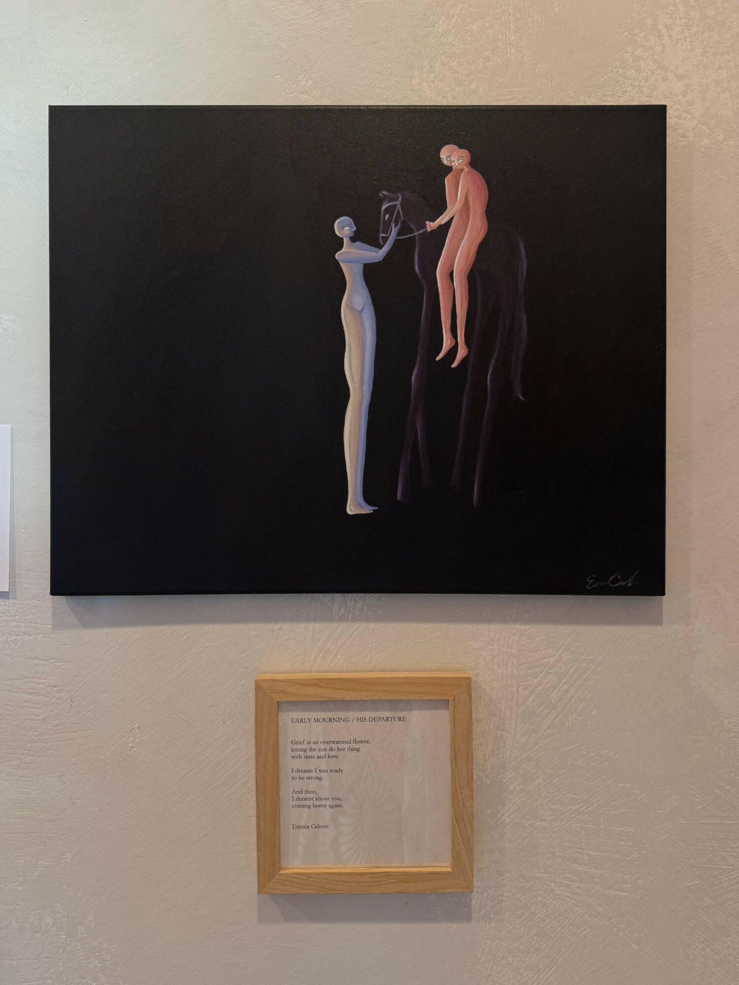 Painting of two abstract human figures, one blue and one pink, against a black background, with a framed text below.