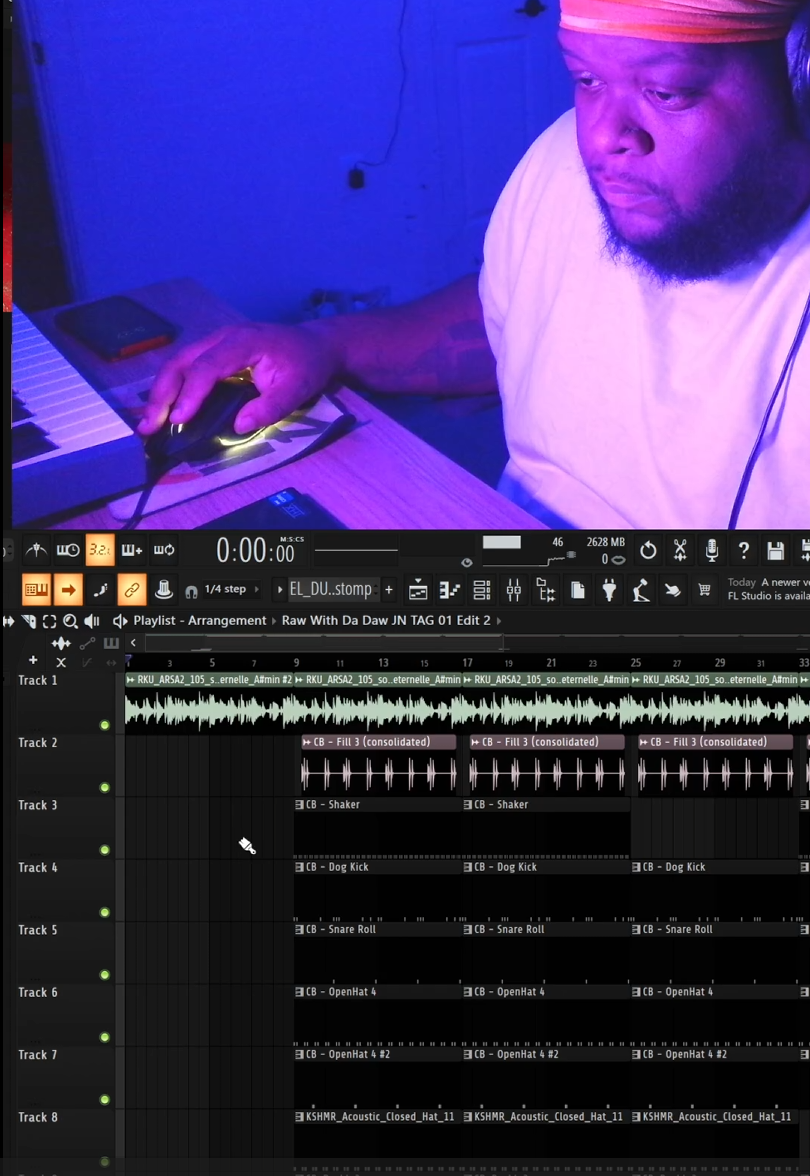 Person wearing a headband and white shirt working on a computer with a colorful background.