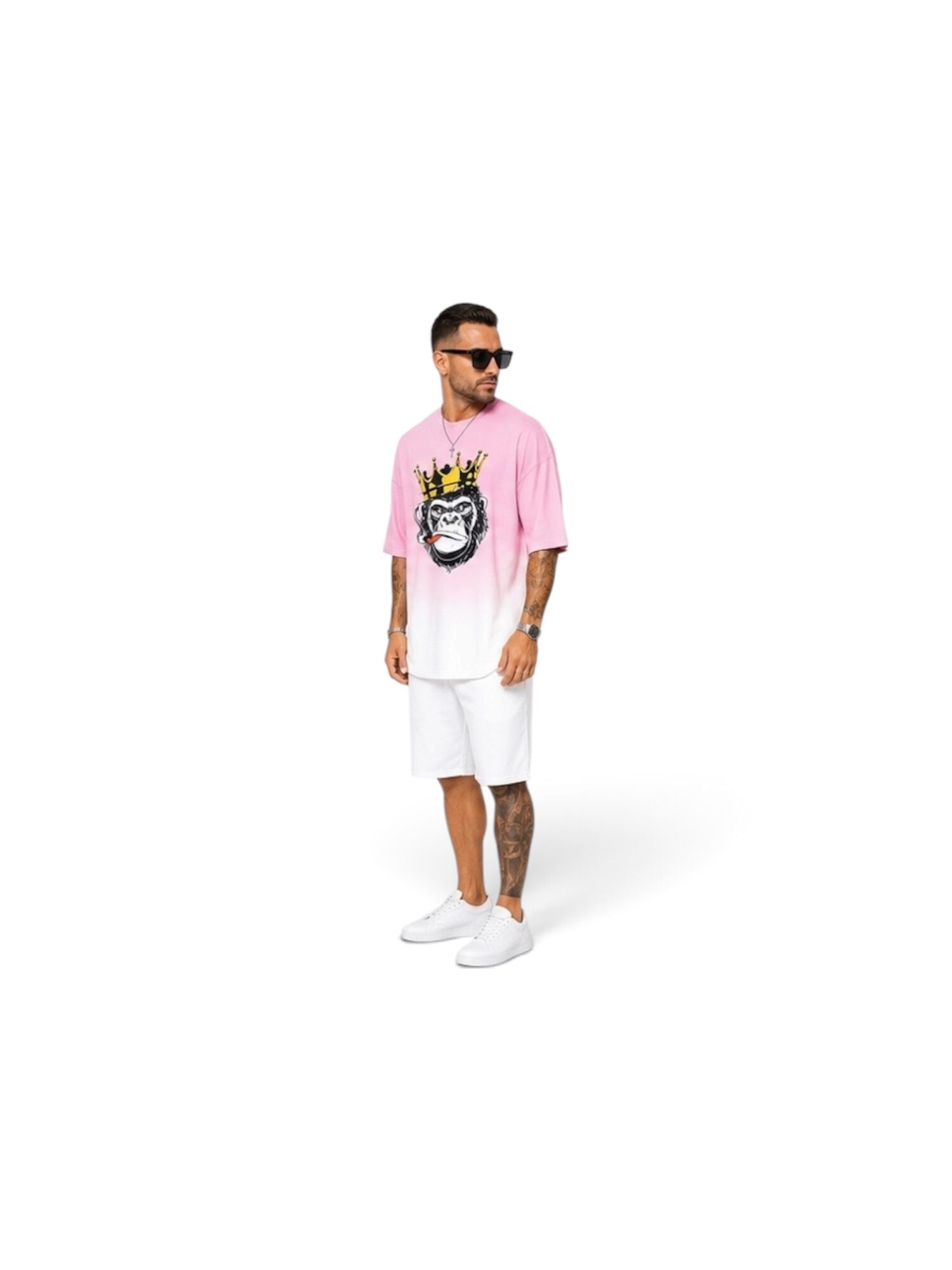 Man wearing sunglasses, pink and white shirt with a graphic, white shorts, and white shoes, standing against a white background.