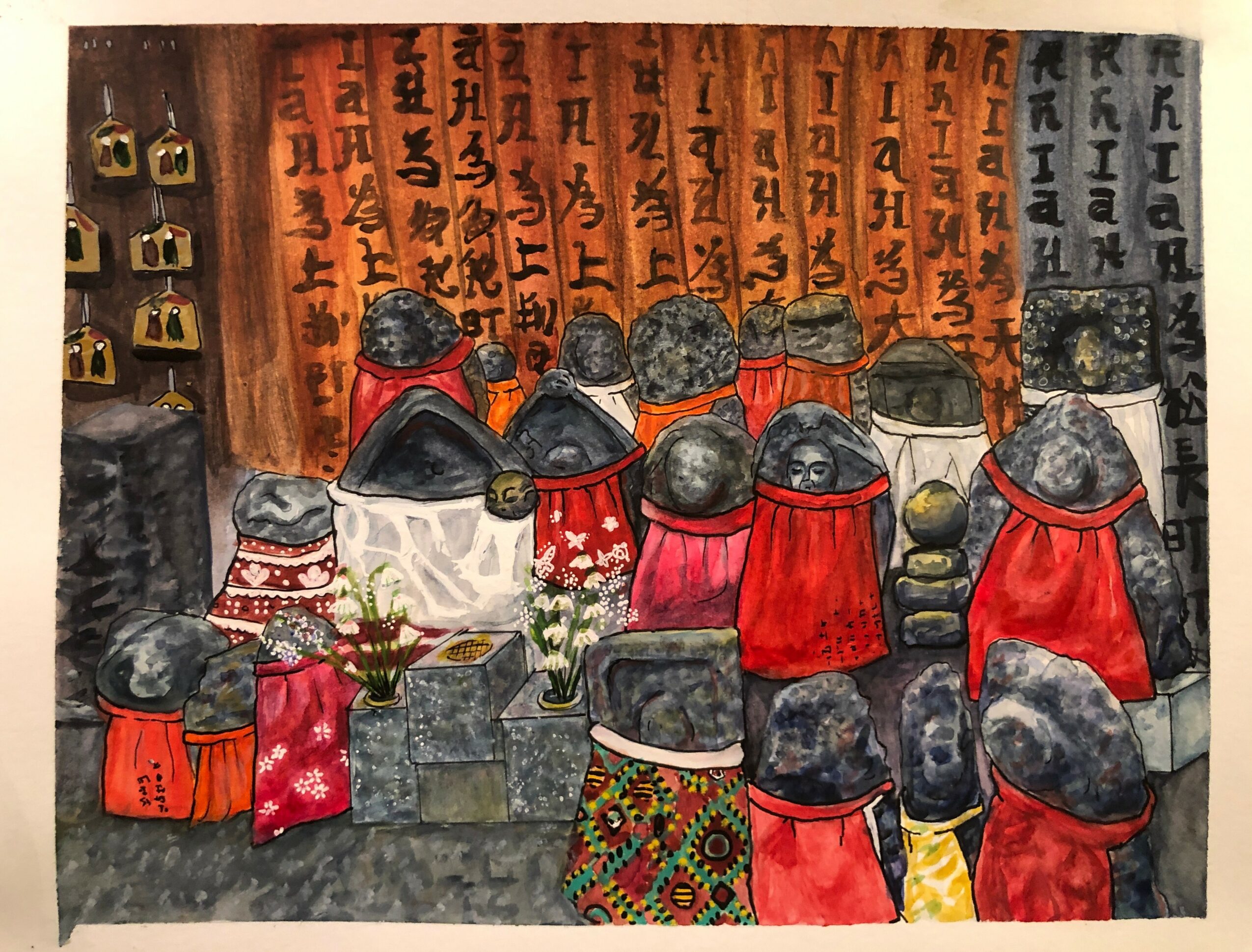 Group of people wearing red and patterned clothing, seated and facing wooden plaques with writing, in an indoor setting.