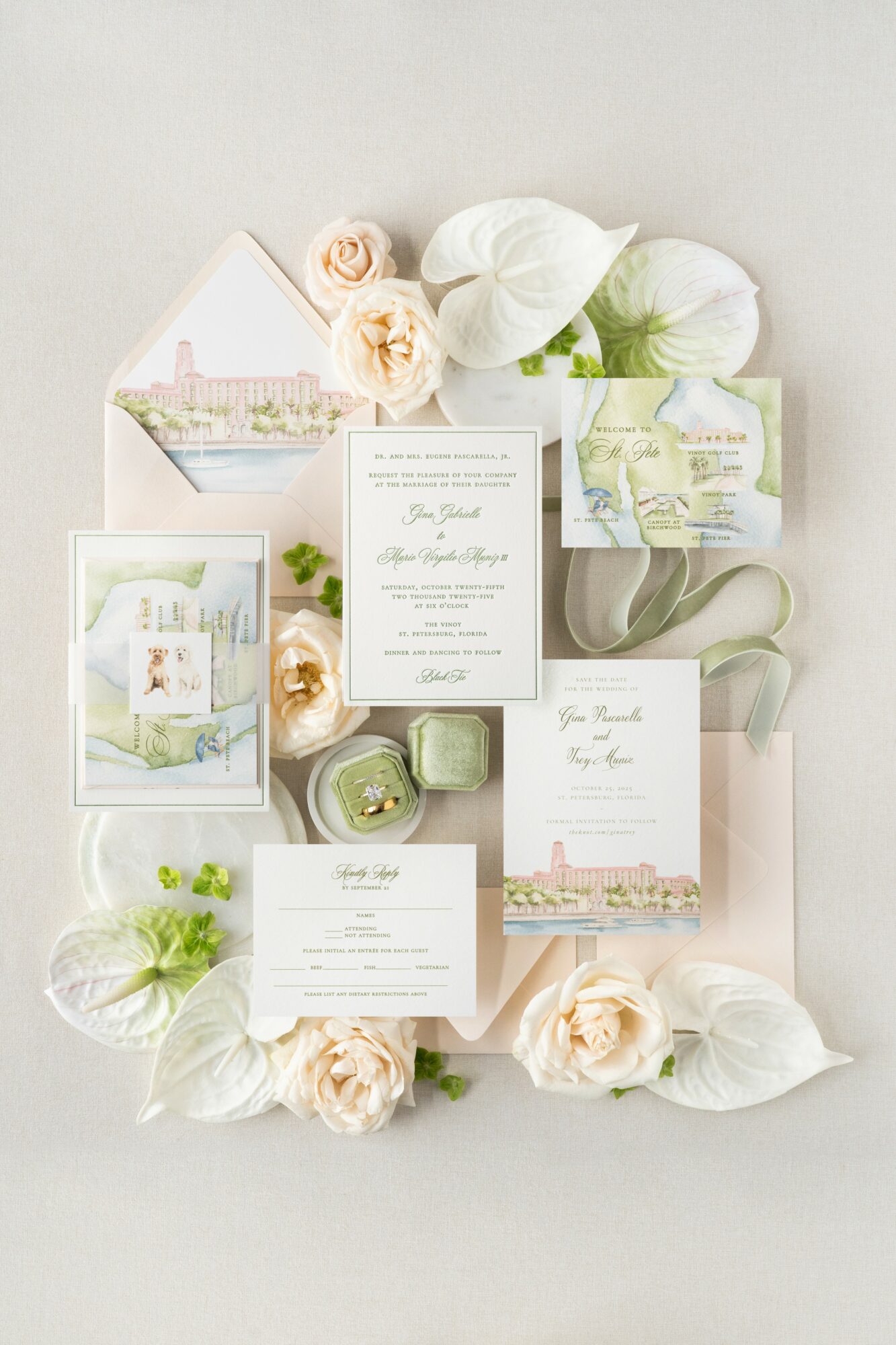 Flat lay of wedding invitations, flowers, and decorative elements on a light background.