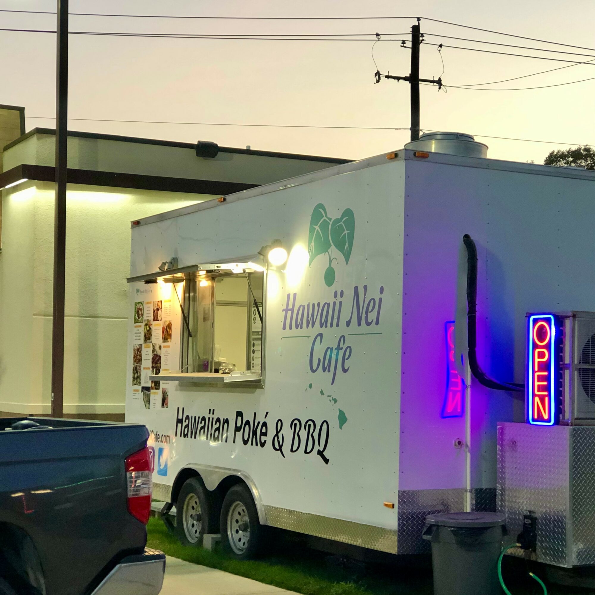 Food truck with Hawaii Nei Cafe sign, serving Hawaiian poke and BBQ, with an open sign and a window for orders.