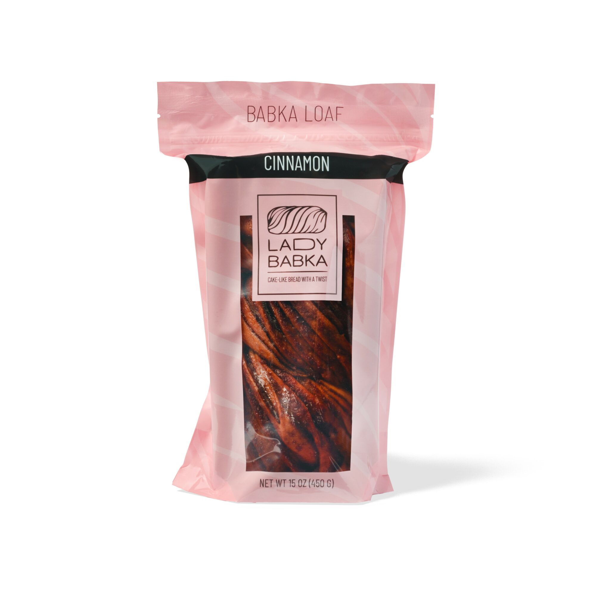 Pink packaging of cinnamon-flavored babka loaf with a label and transparent window showing the bread inside.