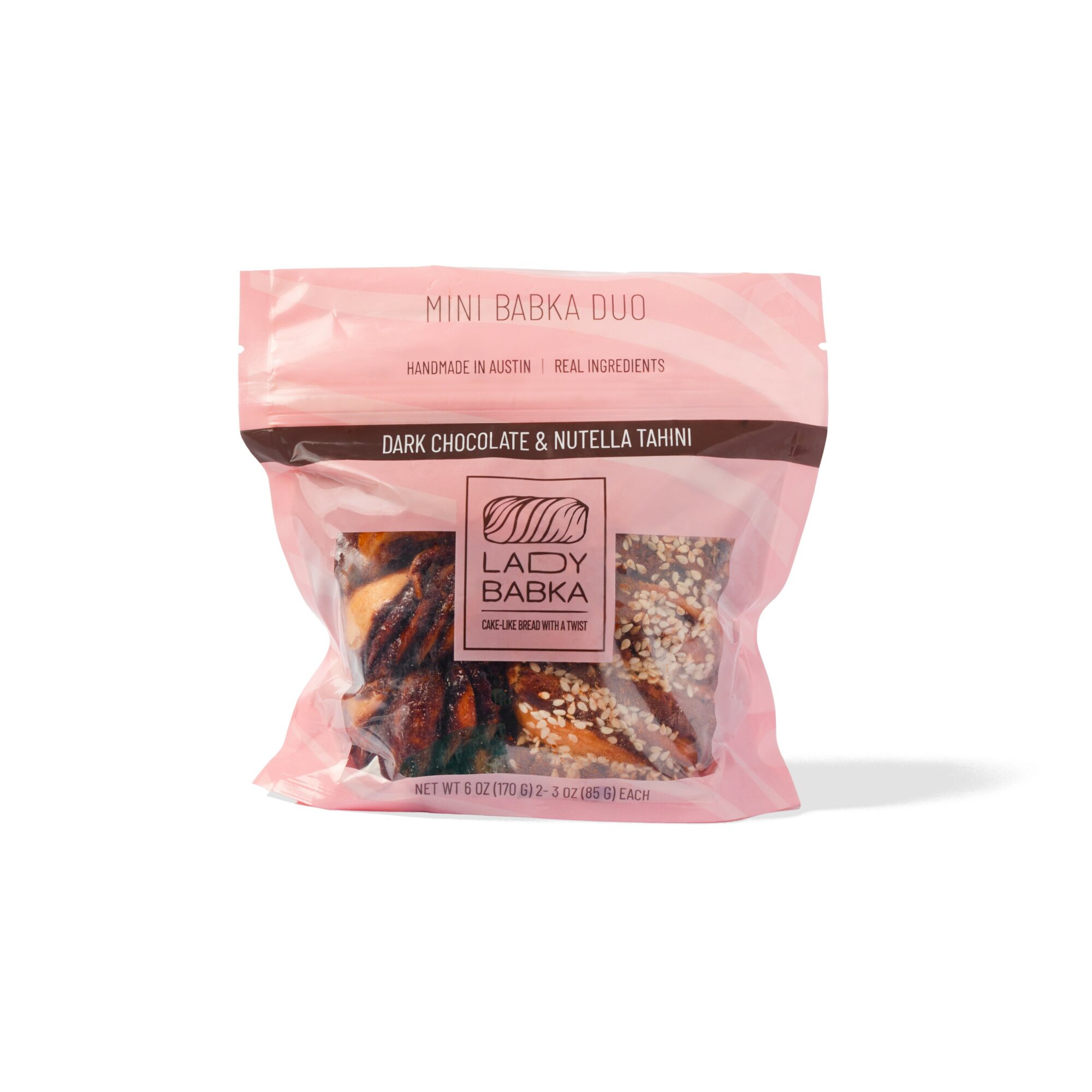 Pink packaging of Lady Babka dark chocolate and Nutella tahini babka, with visible babka pieces inside, on a white background.
