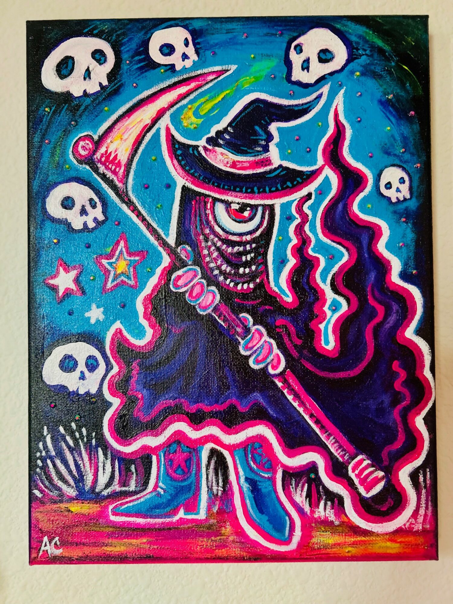 A witch with a pointed hat and flowing dress holding a broomstick, surrounded by skulls and stars, against a colorful background.
