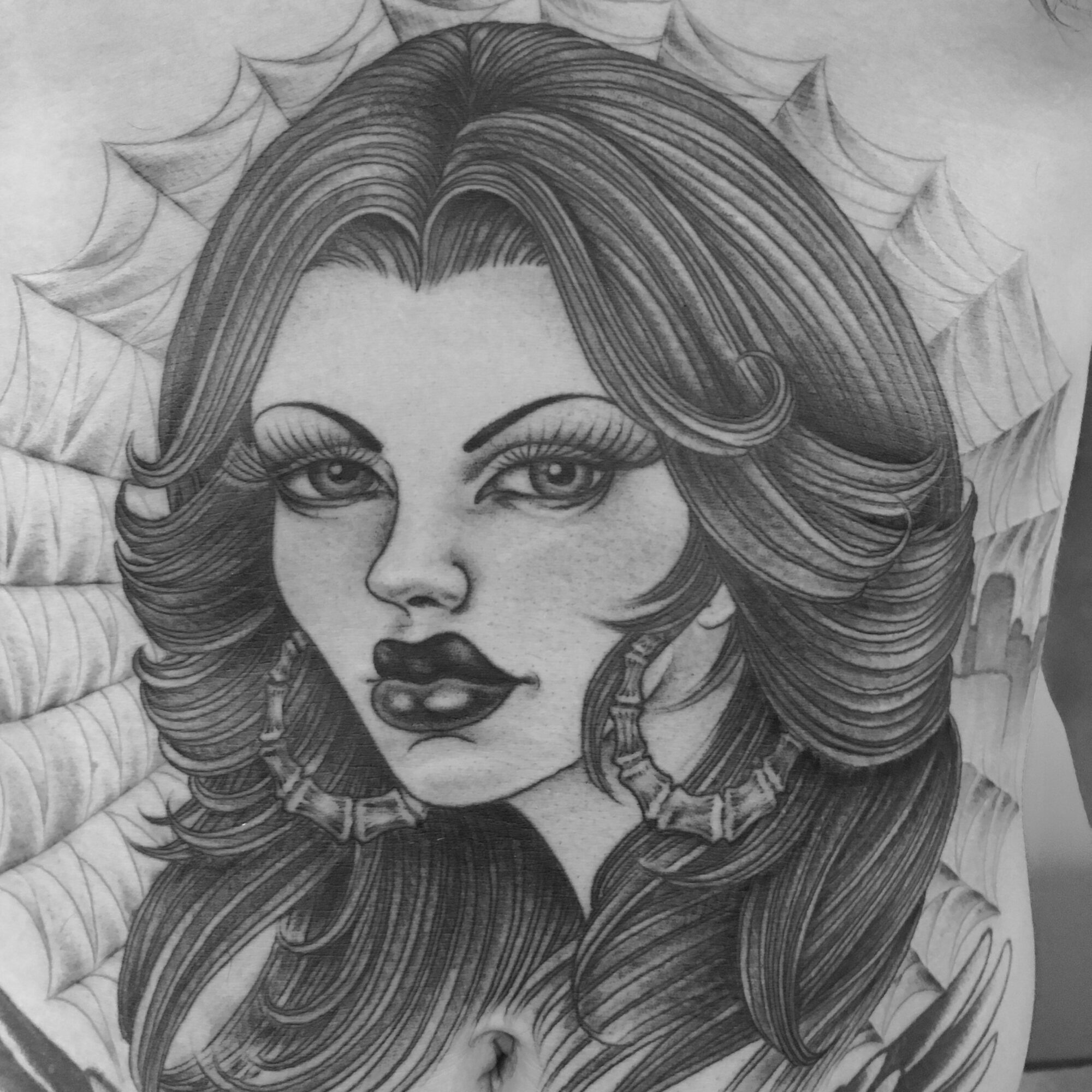 Detailed black and white drawing of a woman with long, wavy hair, full lips, and expressive eyes, with a decorative background.