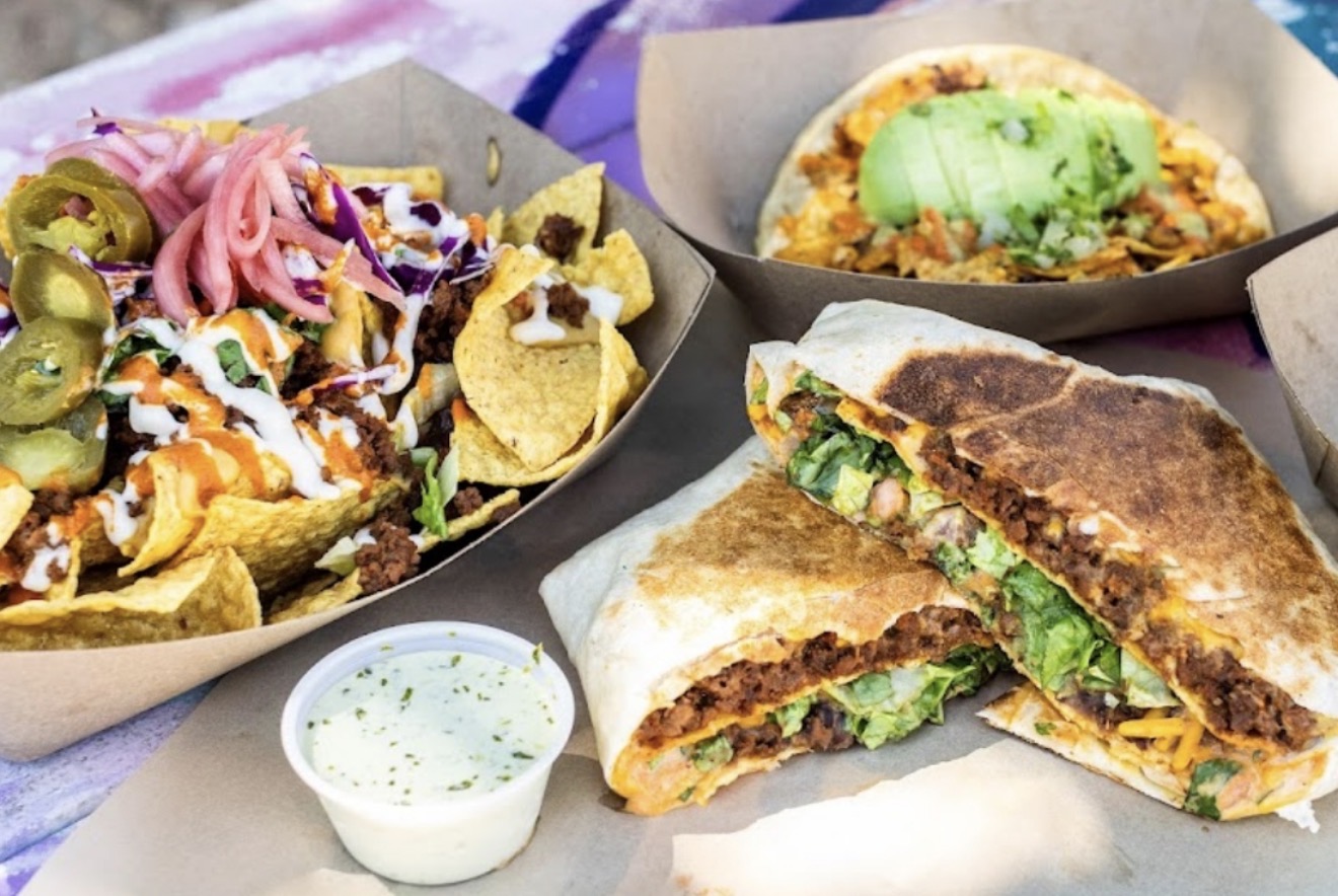 Three dishes: a taco with toppings, a quesadilla, and a bowl of sauce, on a table with a purple cloth.