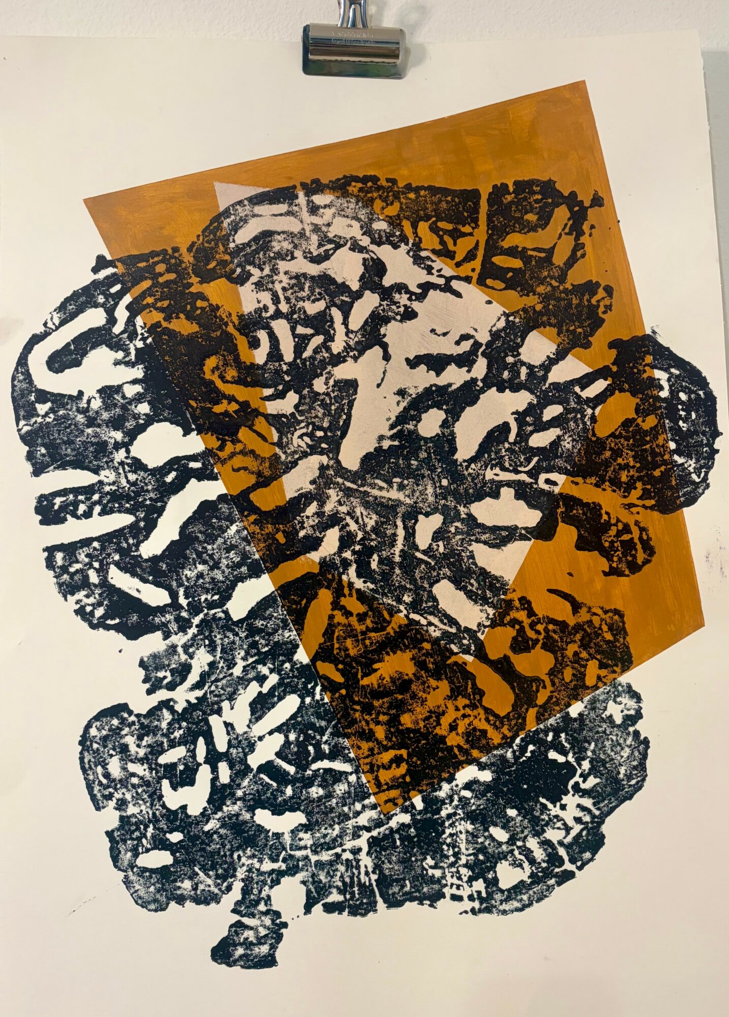 Black abstract print on white background with an orange overlay, featuring complex shapes and patterns.
