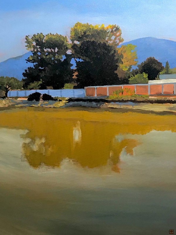 Landscape painting of trees, a brick wall, and a body of water reflecting the scene, with mountains in the background.