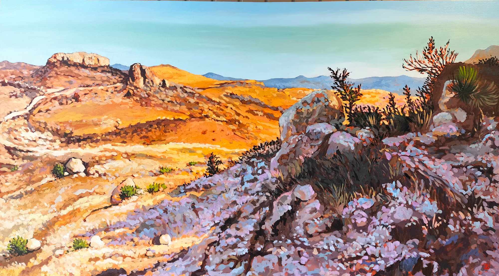 Landscape painting of rocky terrain with desert plants, mountains in the background, and a clear sky.