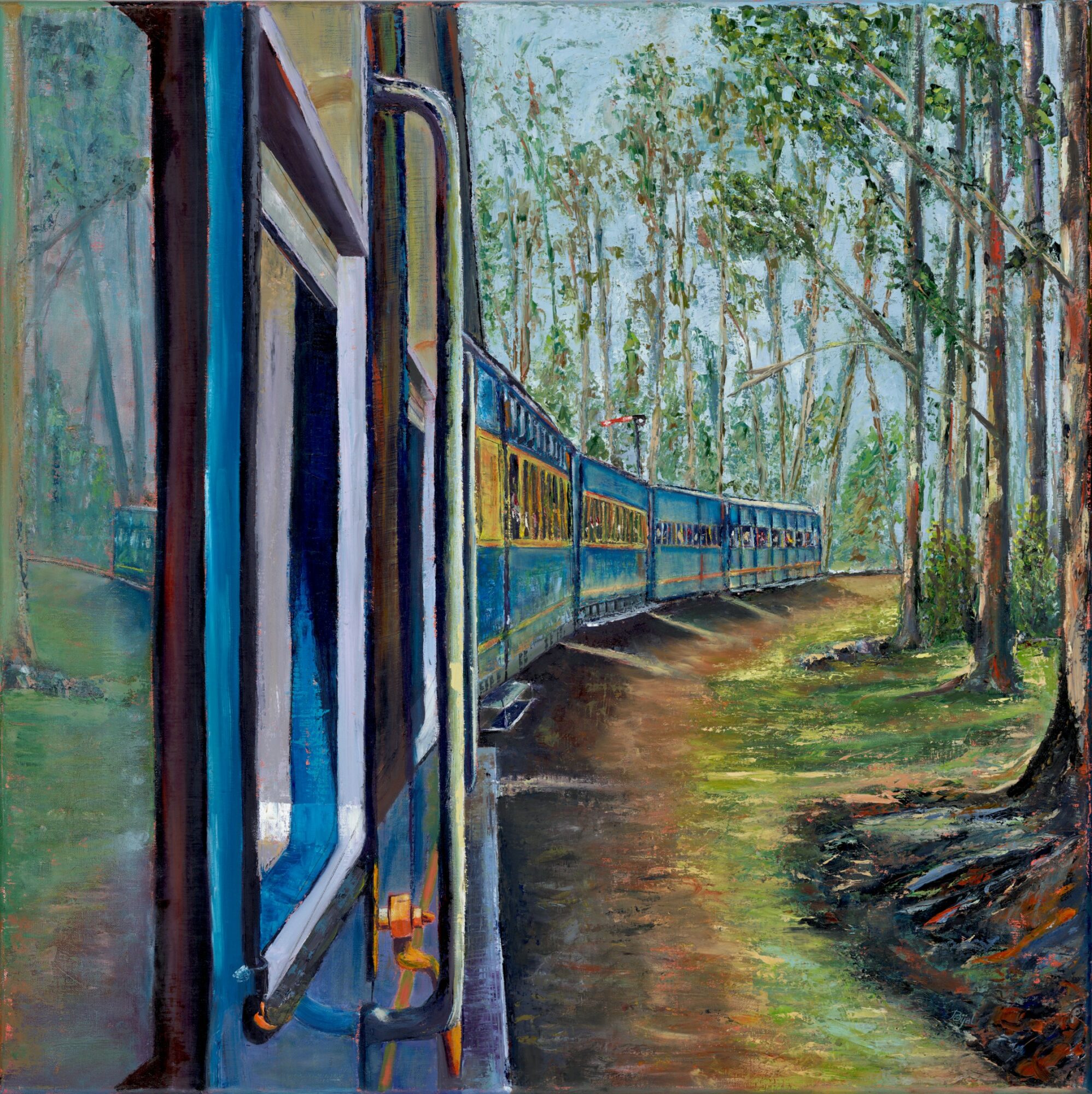 Train moving through a forested area with trees and a dirt path alongside the tracks.