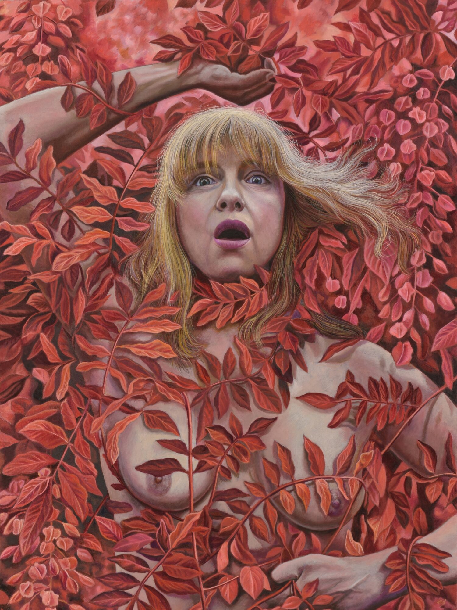 Woman with blonde hair surrounded by red leaves, with a surprised expression, partially obscured by foliage.