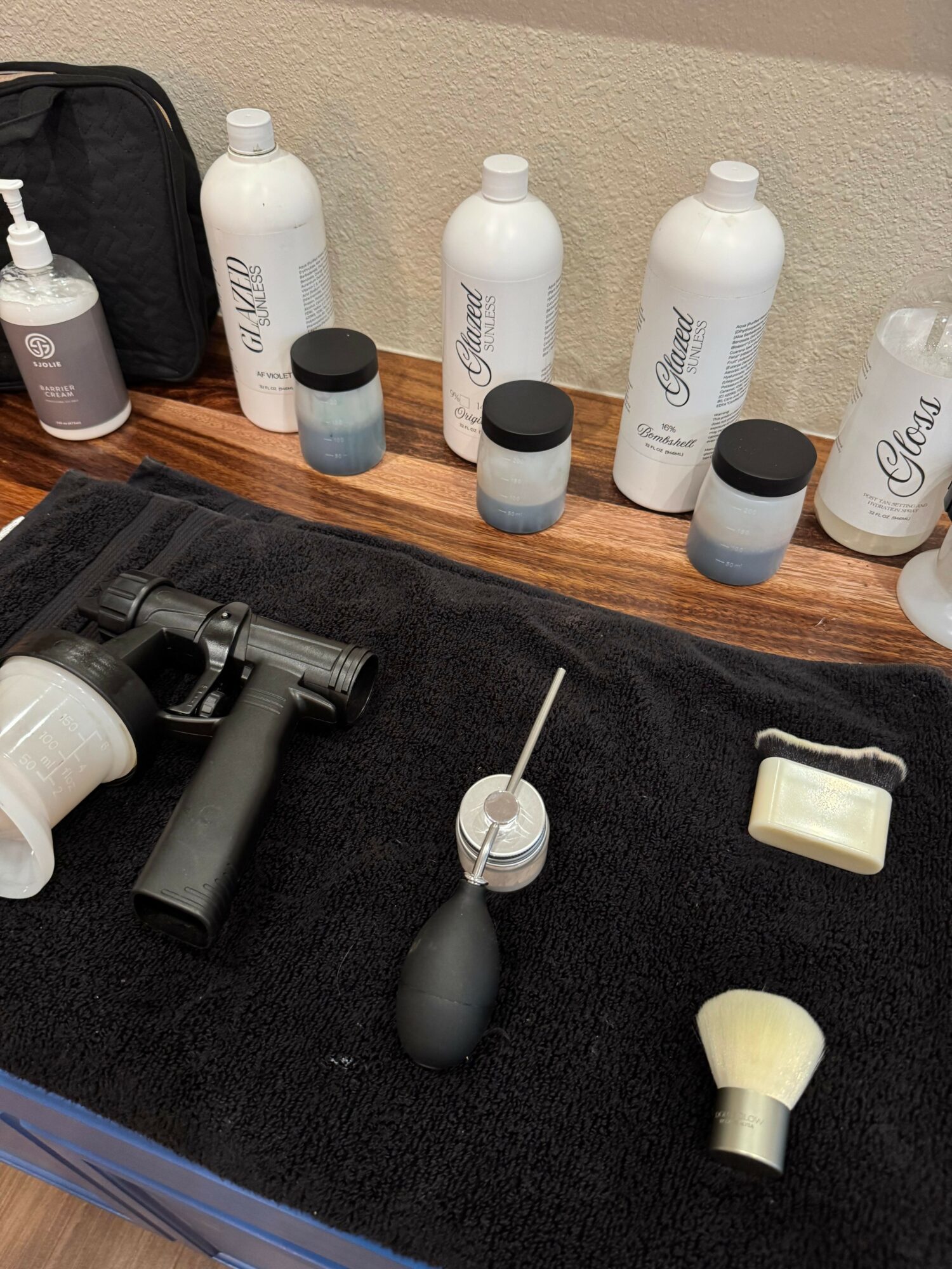 Nail care tools and products on a black cloth, including bottles, a brush, and a tool with a handle.