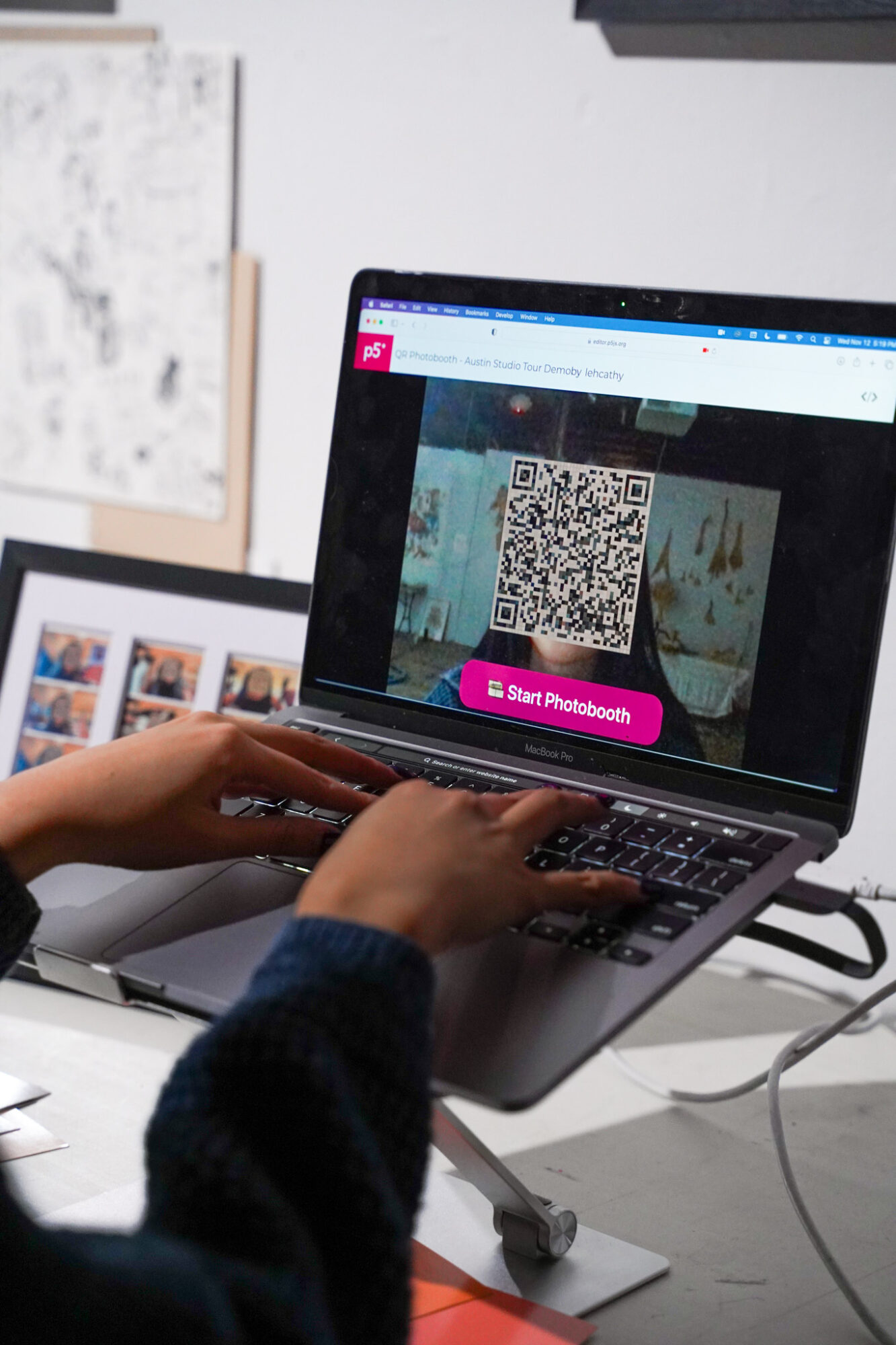 Person using a laptop with a QR code on the screen, pink button says 'Start Facebook'.