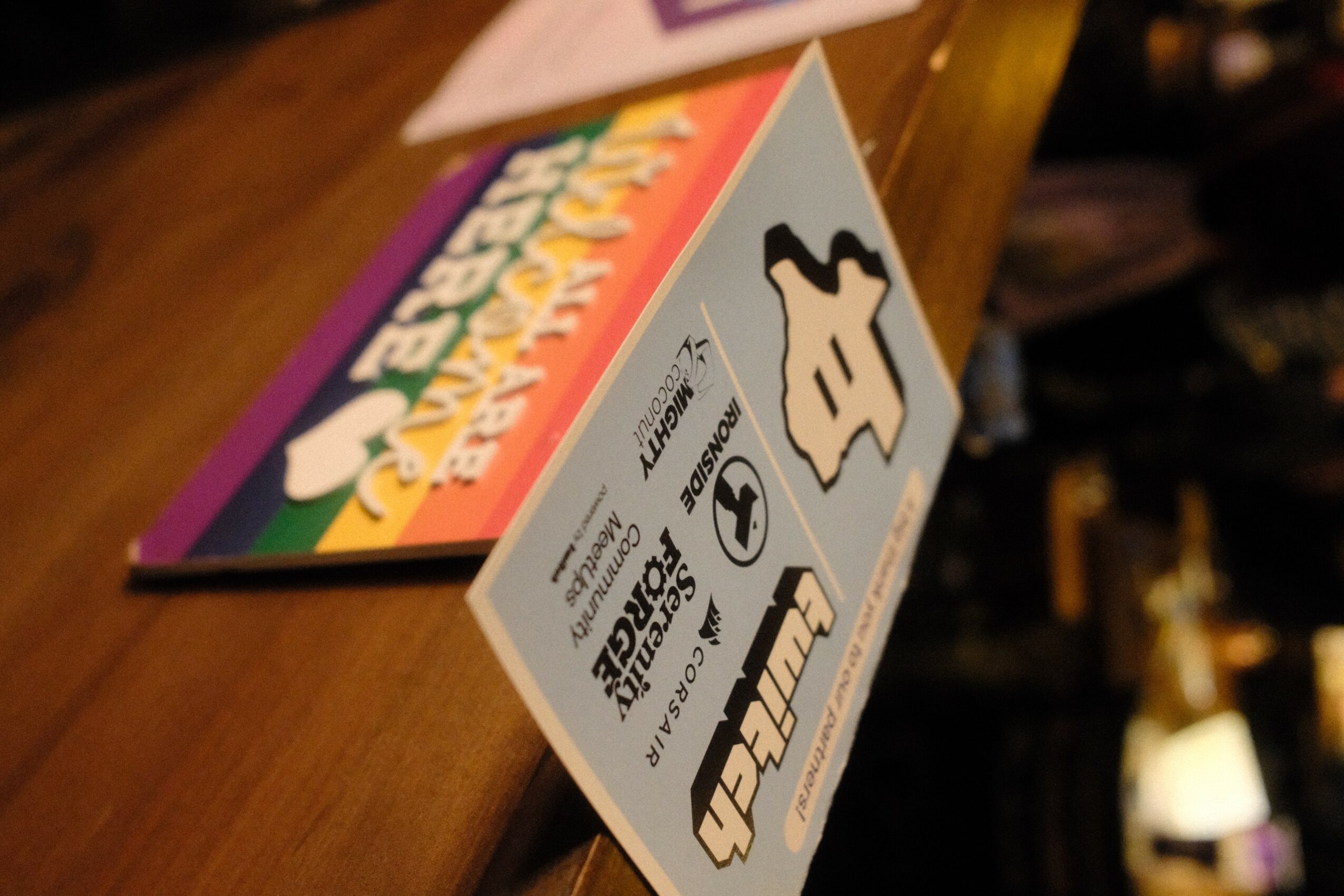 Colorful box with cartoon character and text, placed on a wooden surface, viewed from the side.