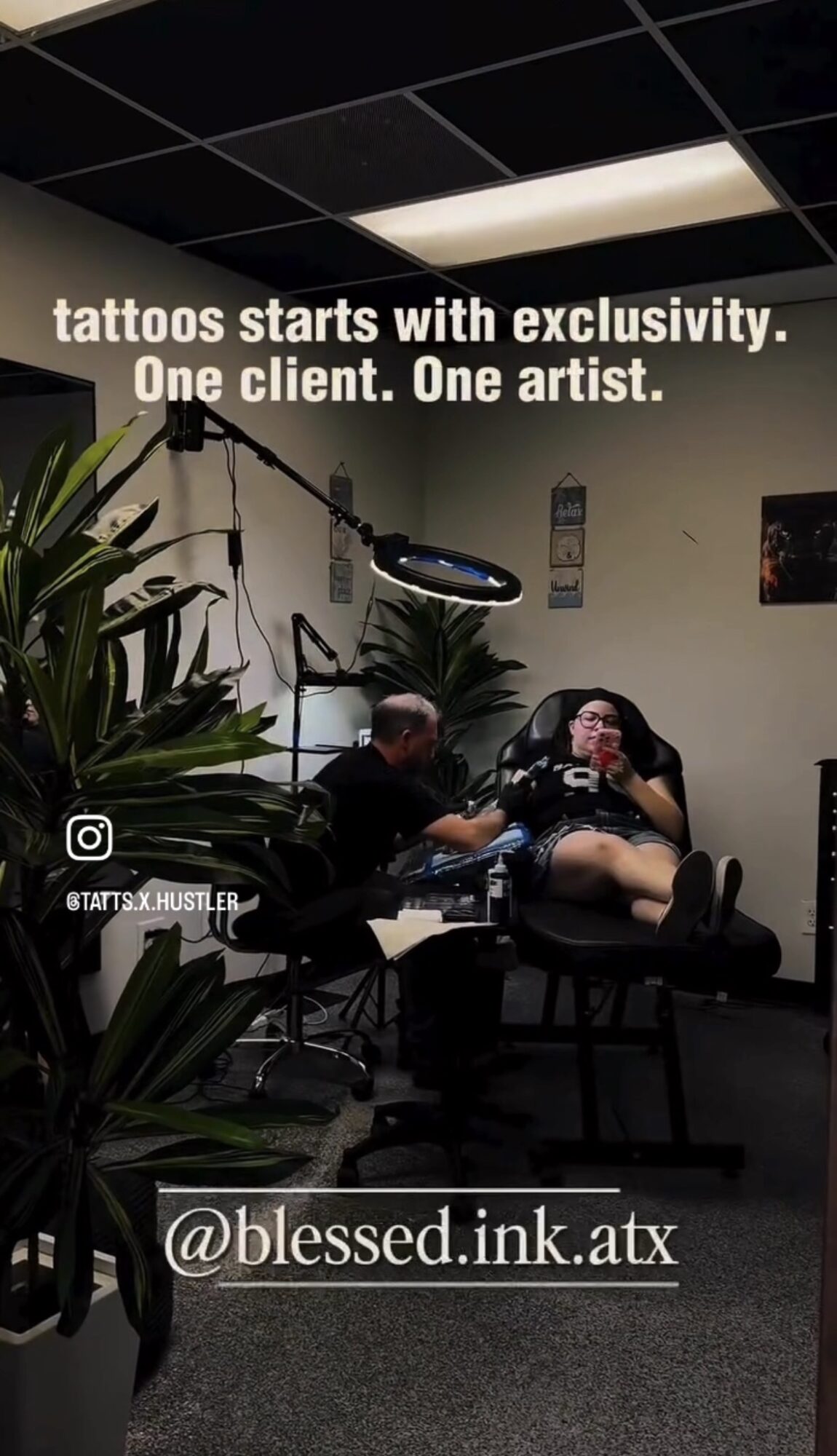 Tattoo studio with two clients getting tattoos, tattoo artist working, plants, and ceiling lights, with text about tattoos and exclusivity.