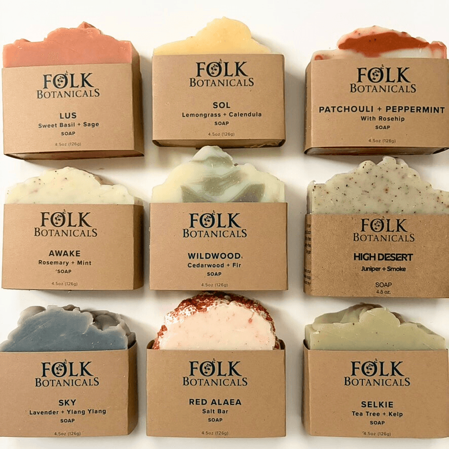 Six soap bars with labels, arranged in two rows of three, each with different scents and colors.
